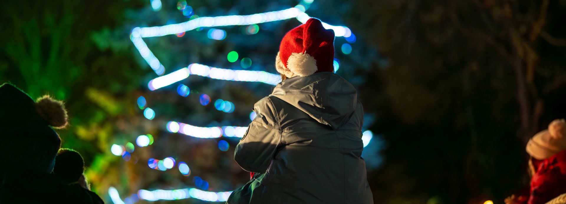 Child sitting on parent's shoulders at a holiday event in Durham Region, Ontario, Canada