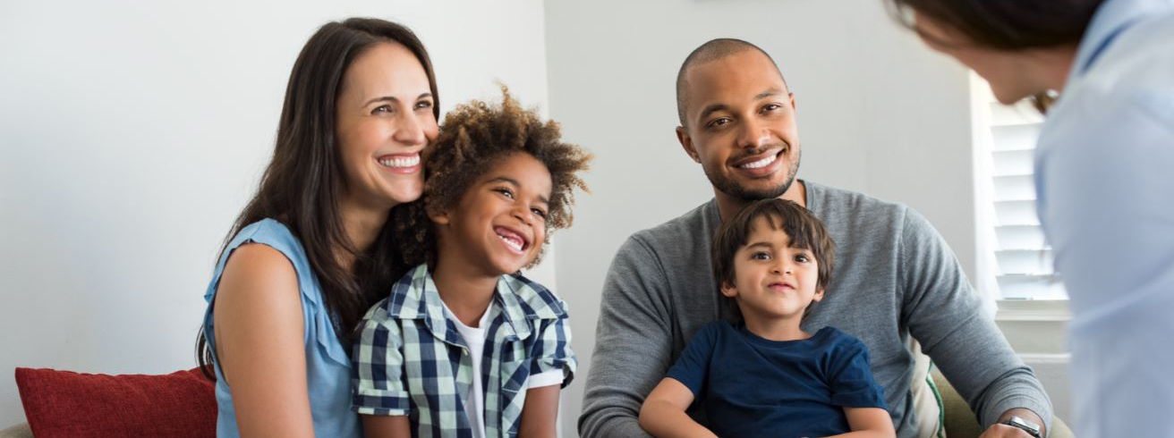 A picture of two adults and two children at a counselling session