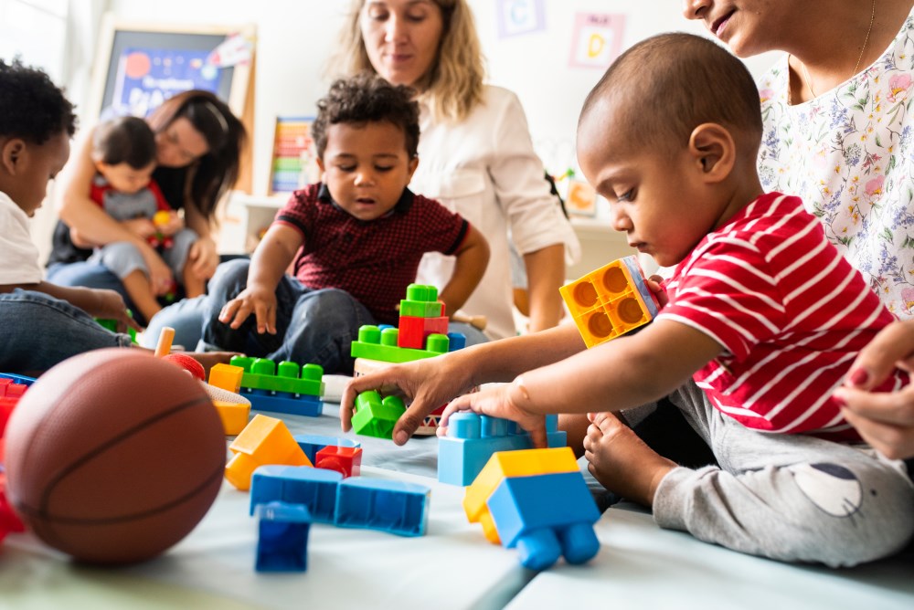 A picture of a diverse group of families and children playing together