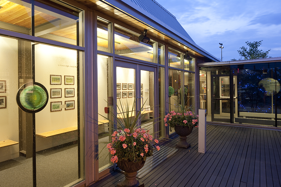 Station Gallery glass orbs on front doors at night