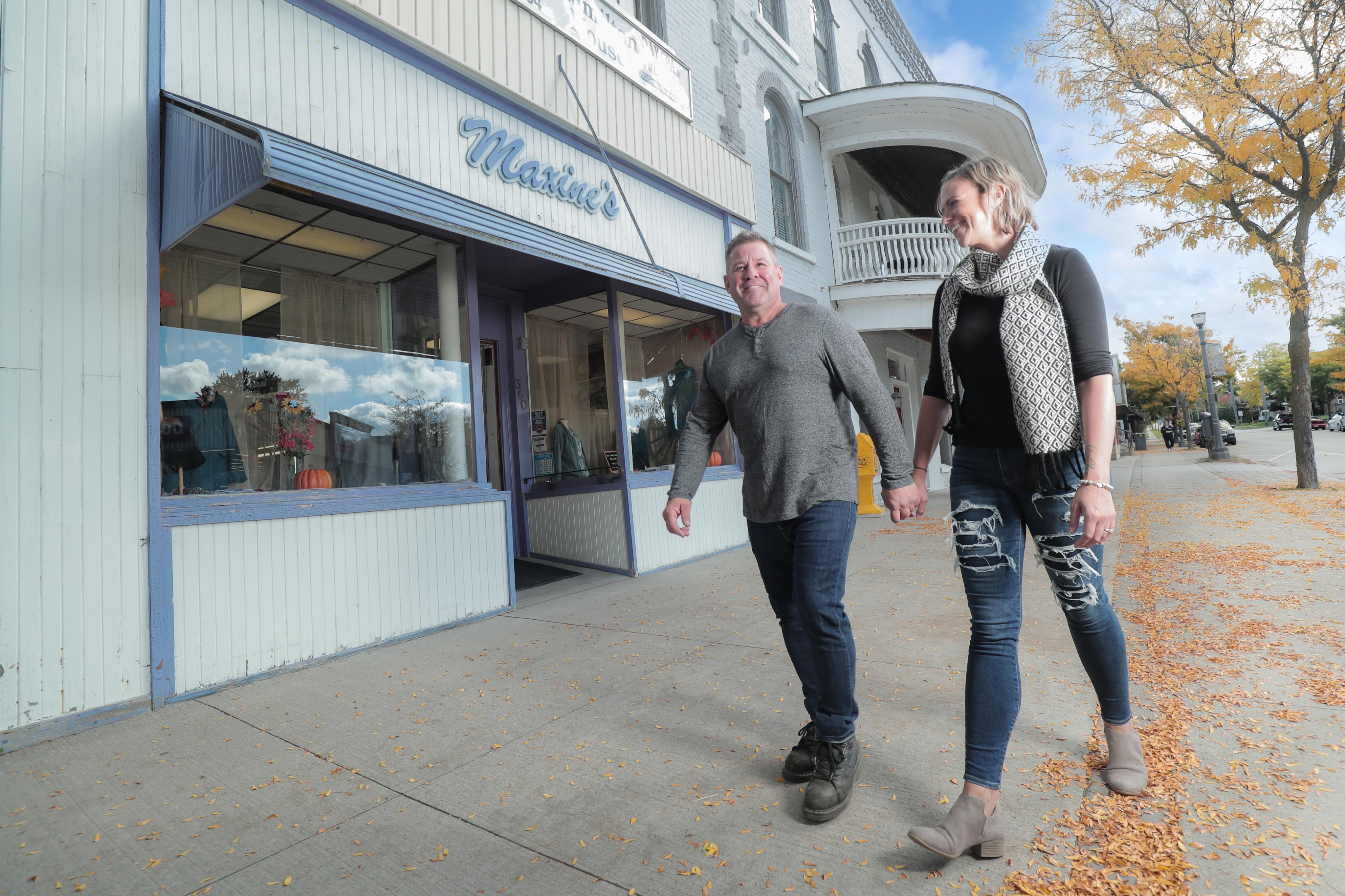 Two people walking down a Downtown Beaverton street