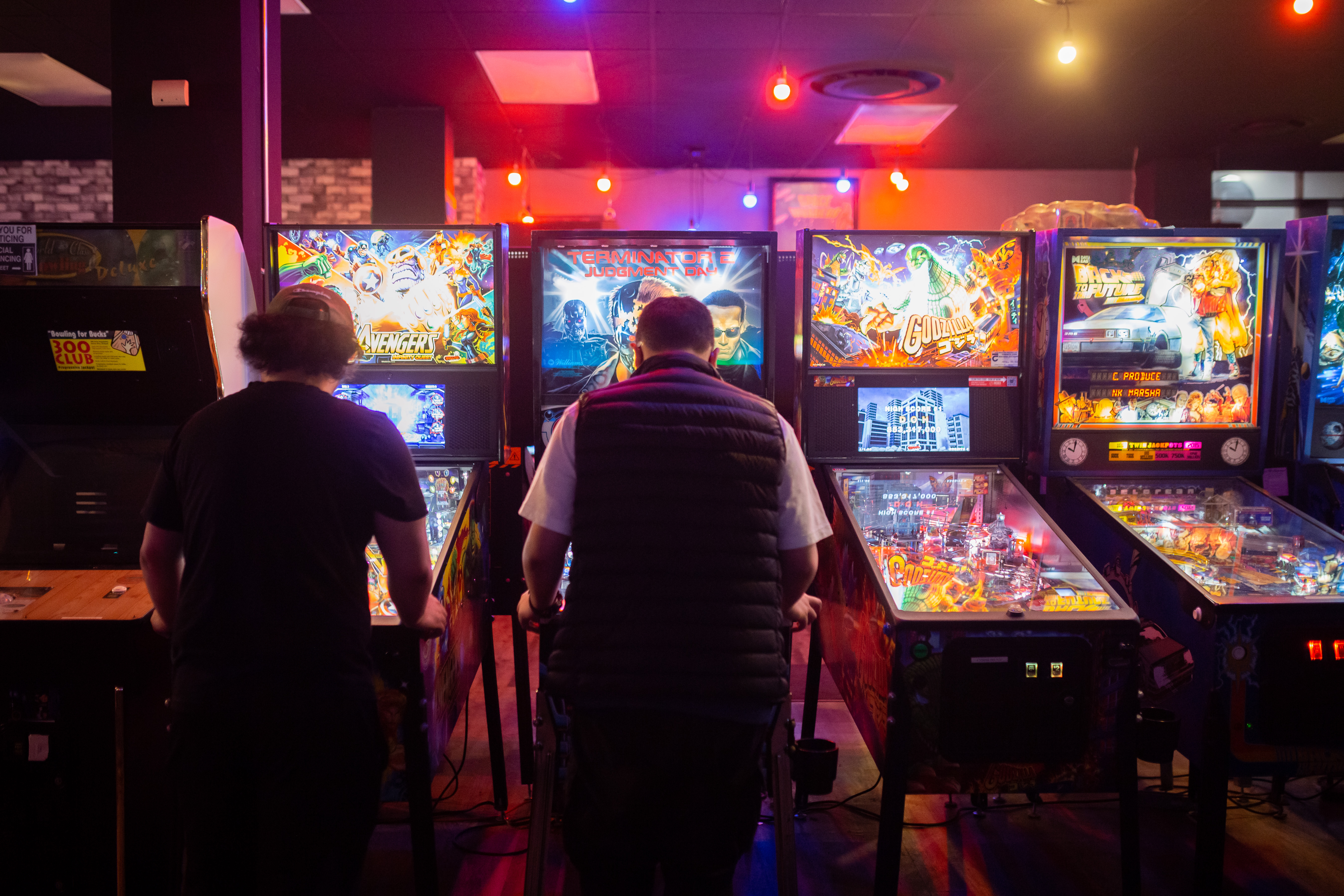 Two kids playing pinball at 8-Bit Beans in downtown Whitby