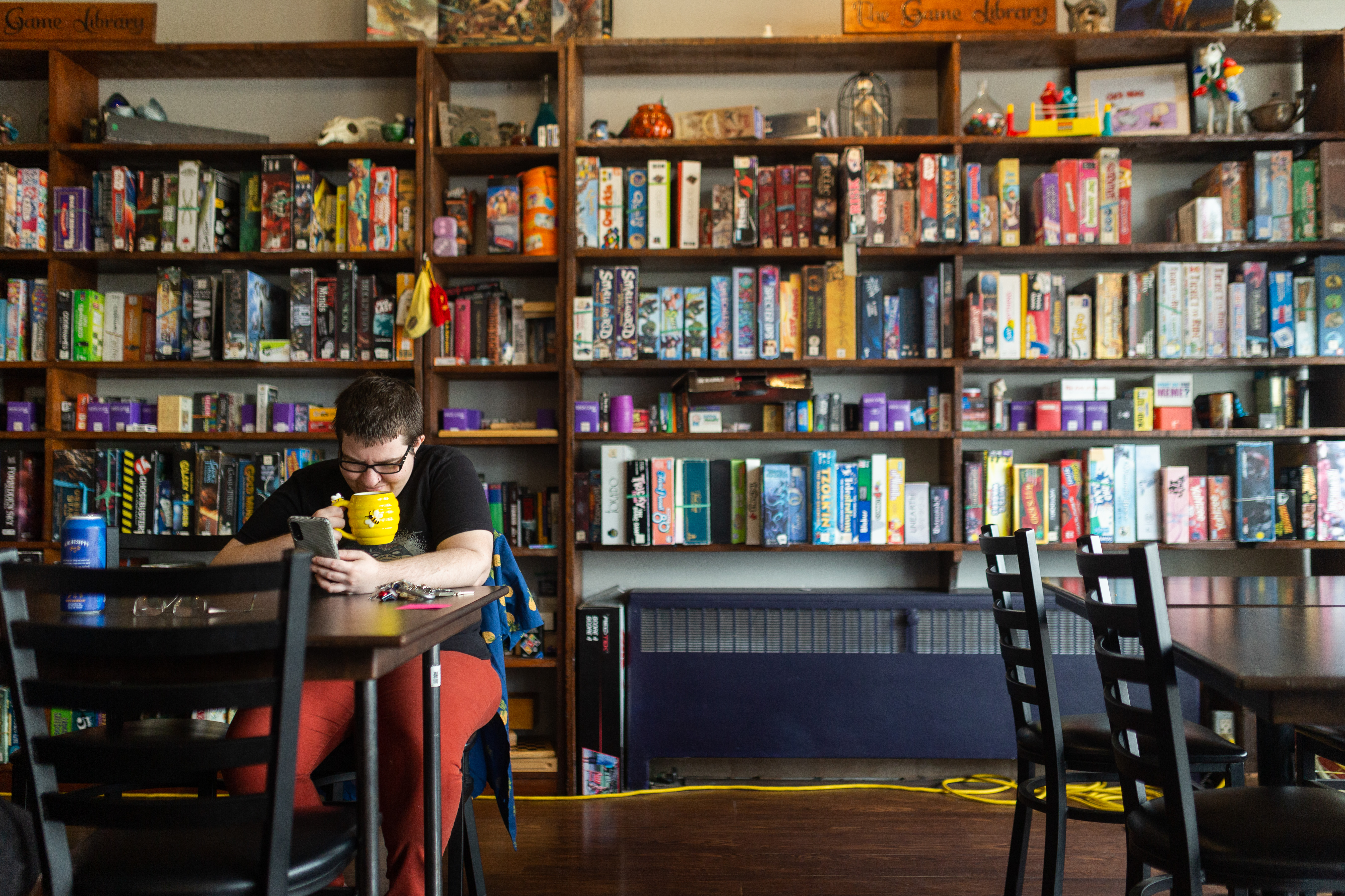 A person drinking from a mug inside Brew Wizards in downtown Oshawa