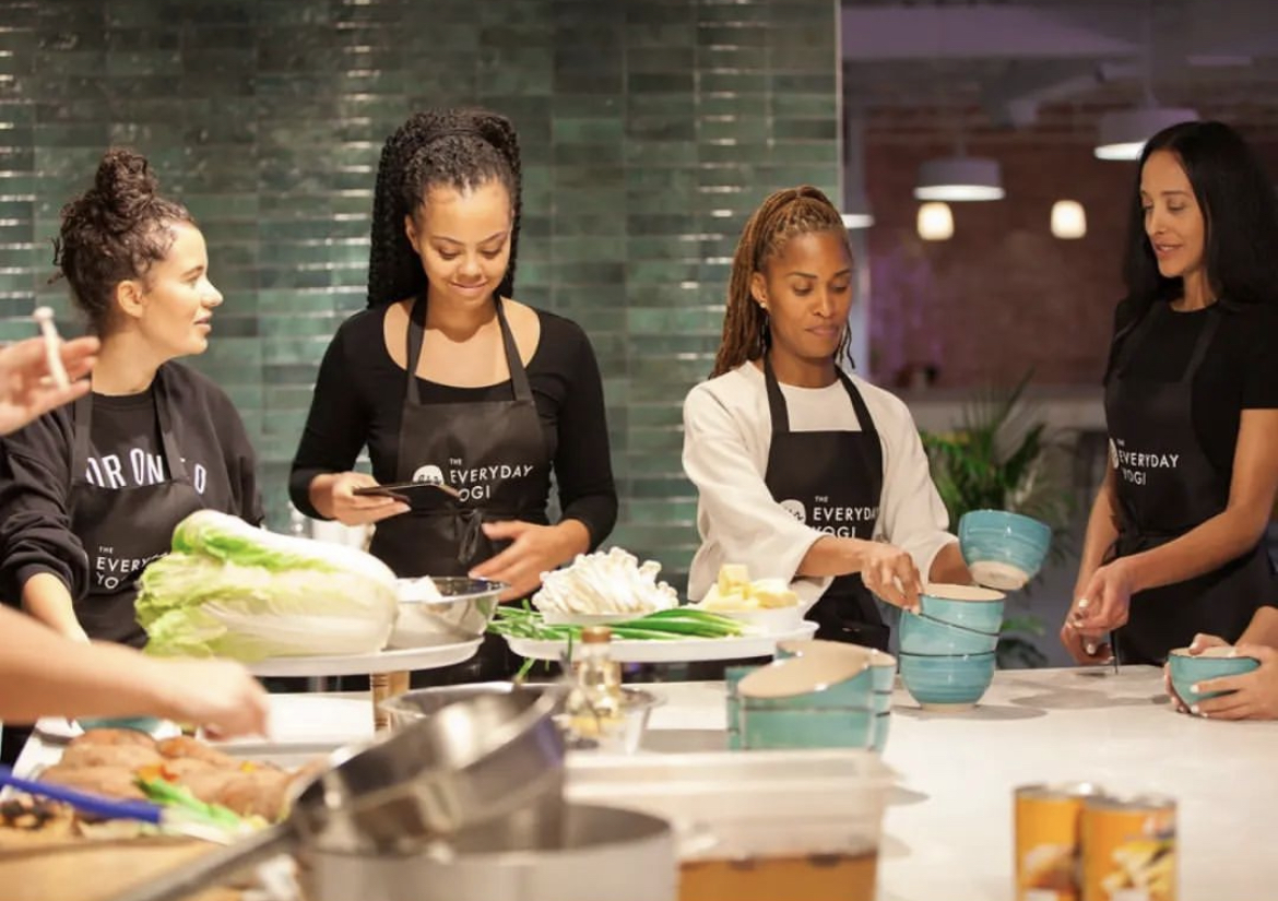 A group of people making food in a cooking class