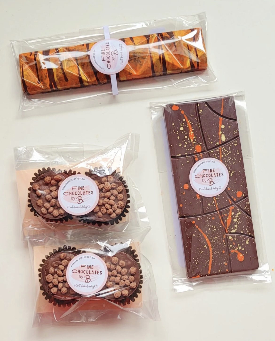 Milk chocolate bars and chocolate cups in clear packaging on a white background