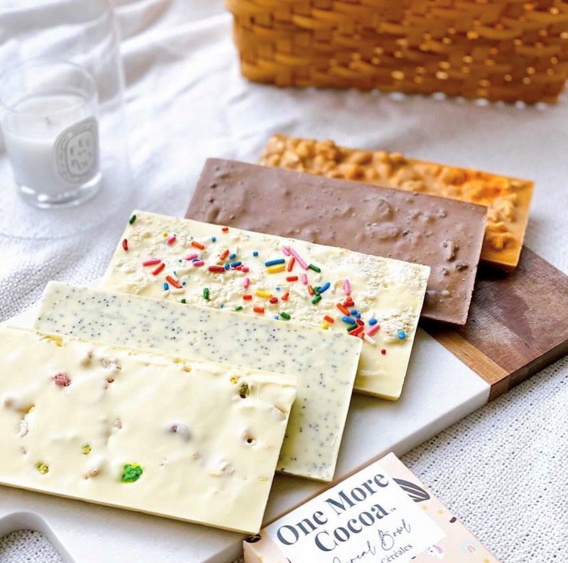 White and dark chocolate bars on a wooden plank