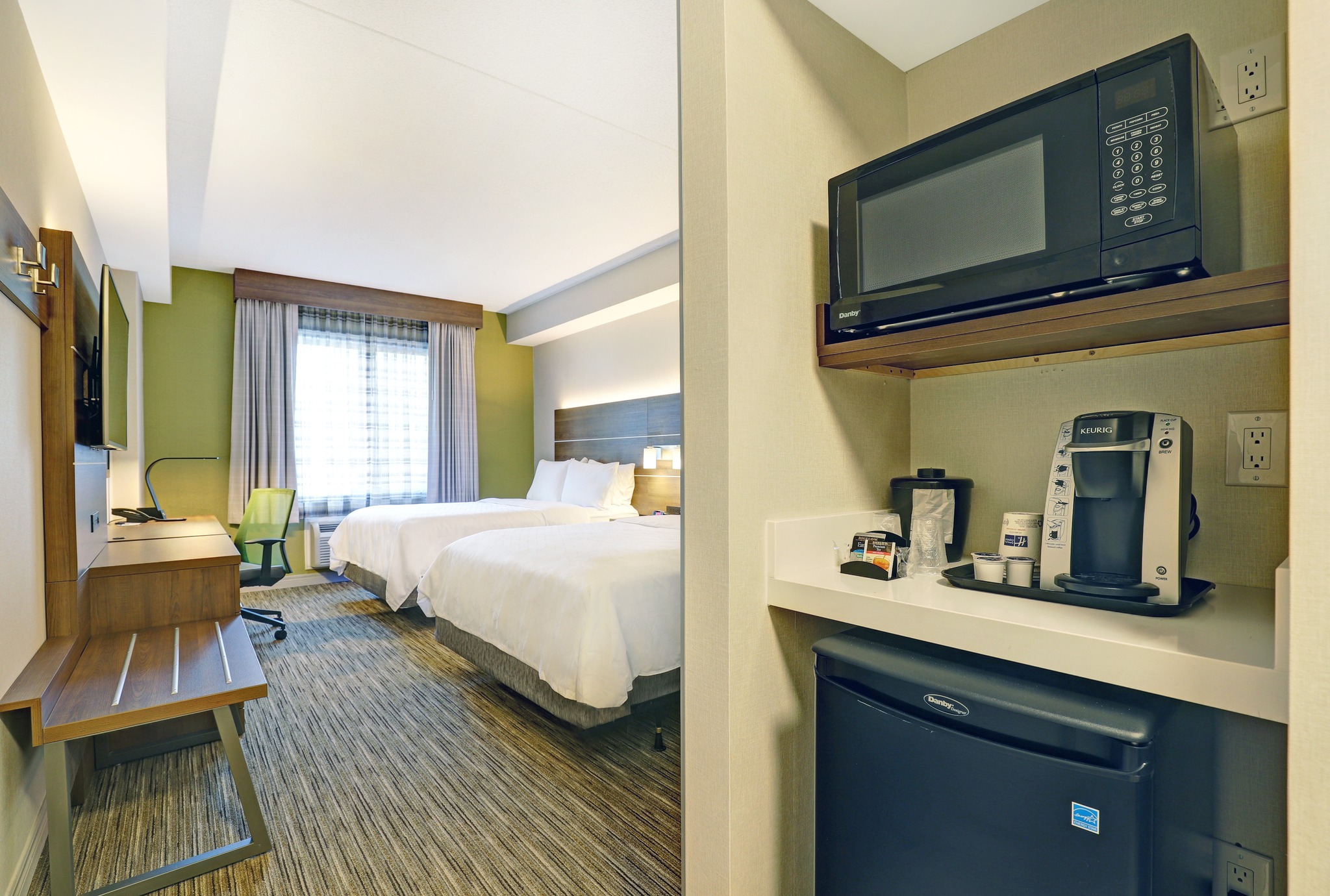 Holiday Inn Express Whitby/Oshawa Hotel guest room with king bed and kitchenette with mini fridge and mircowave