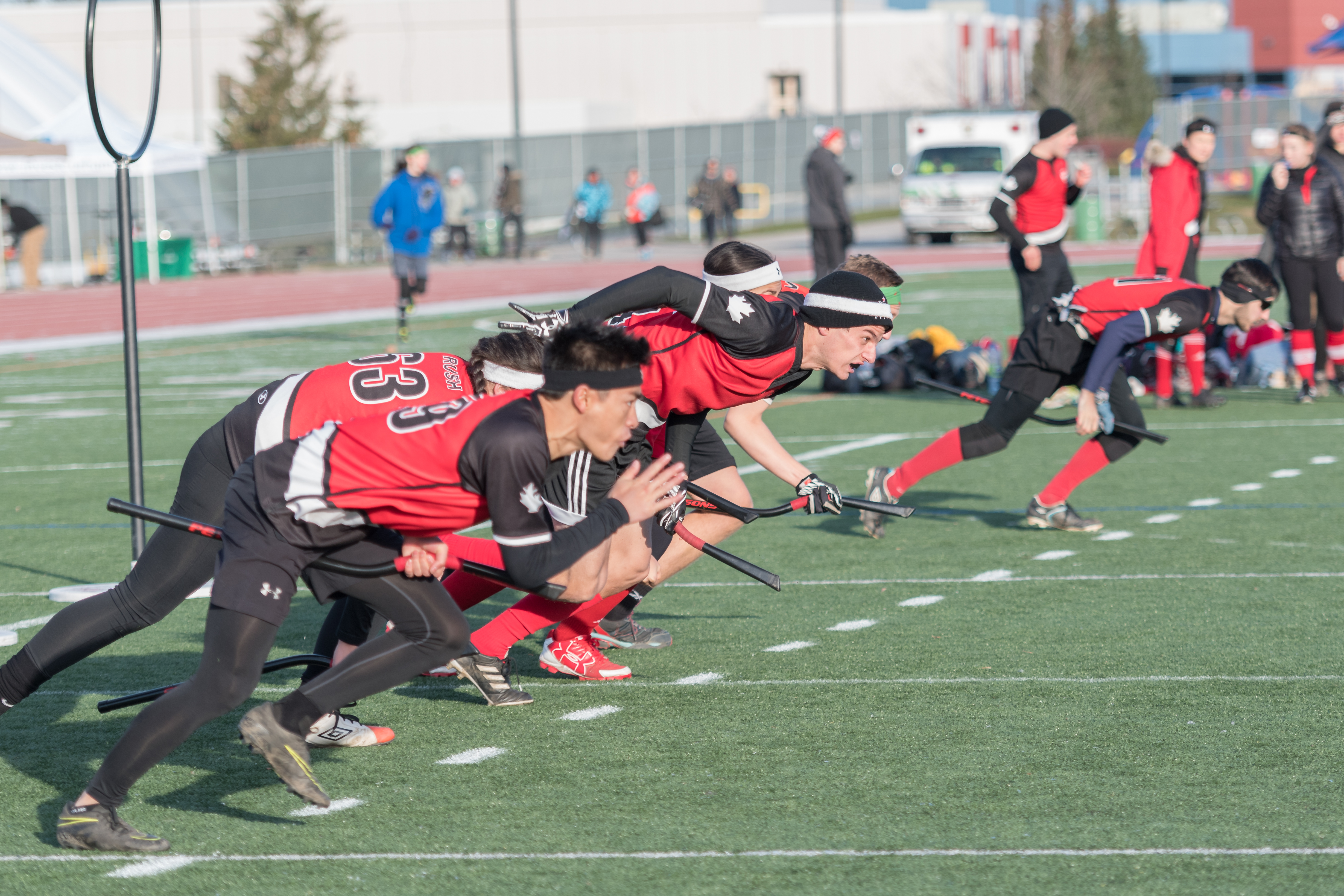 Multiple people running on turf