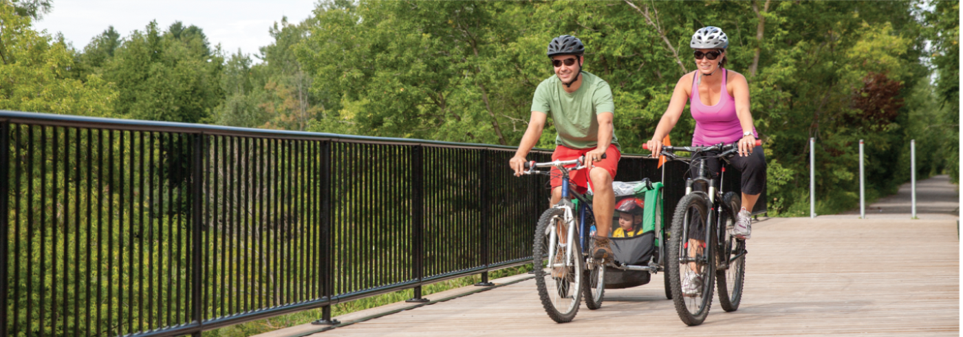 Two cyclists riding bicycles on a bridge