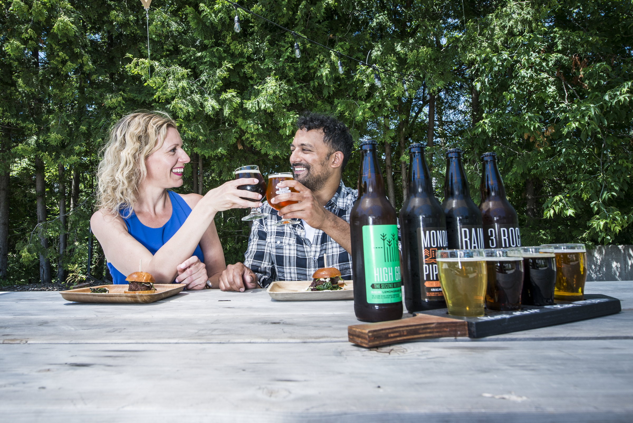 Couple drinking beer on outdoor patio