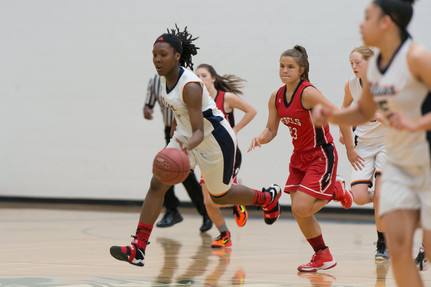 Multiple people playing basketball