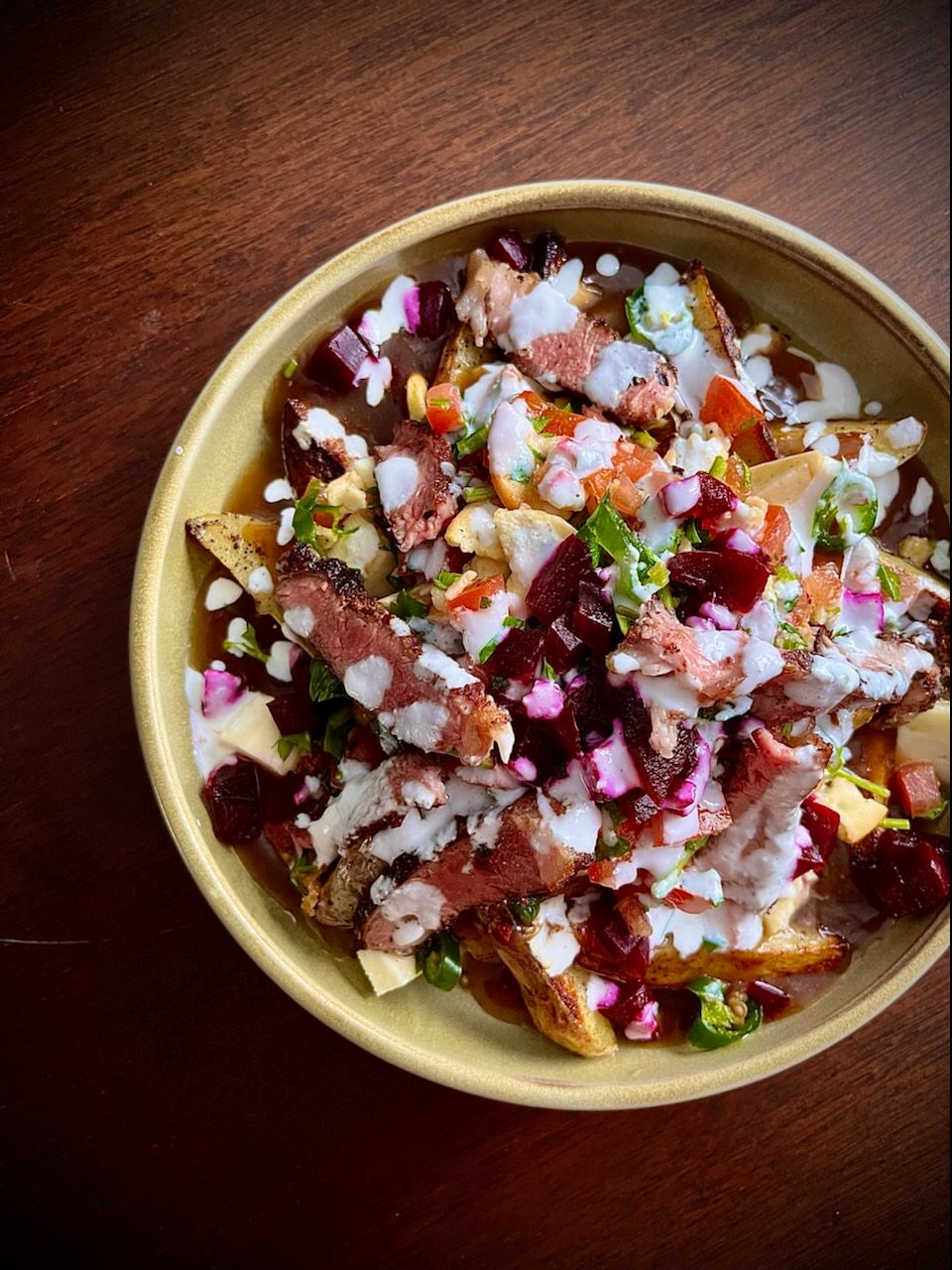 Lamb shawarma poutine in yellow dish