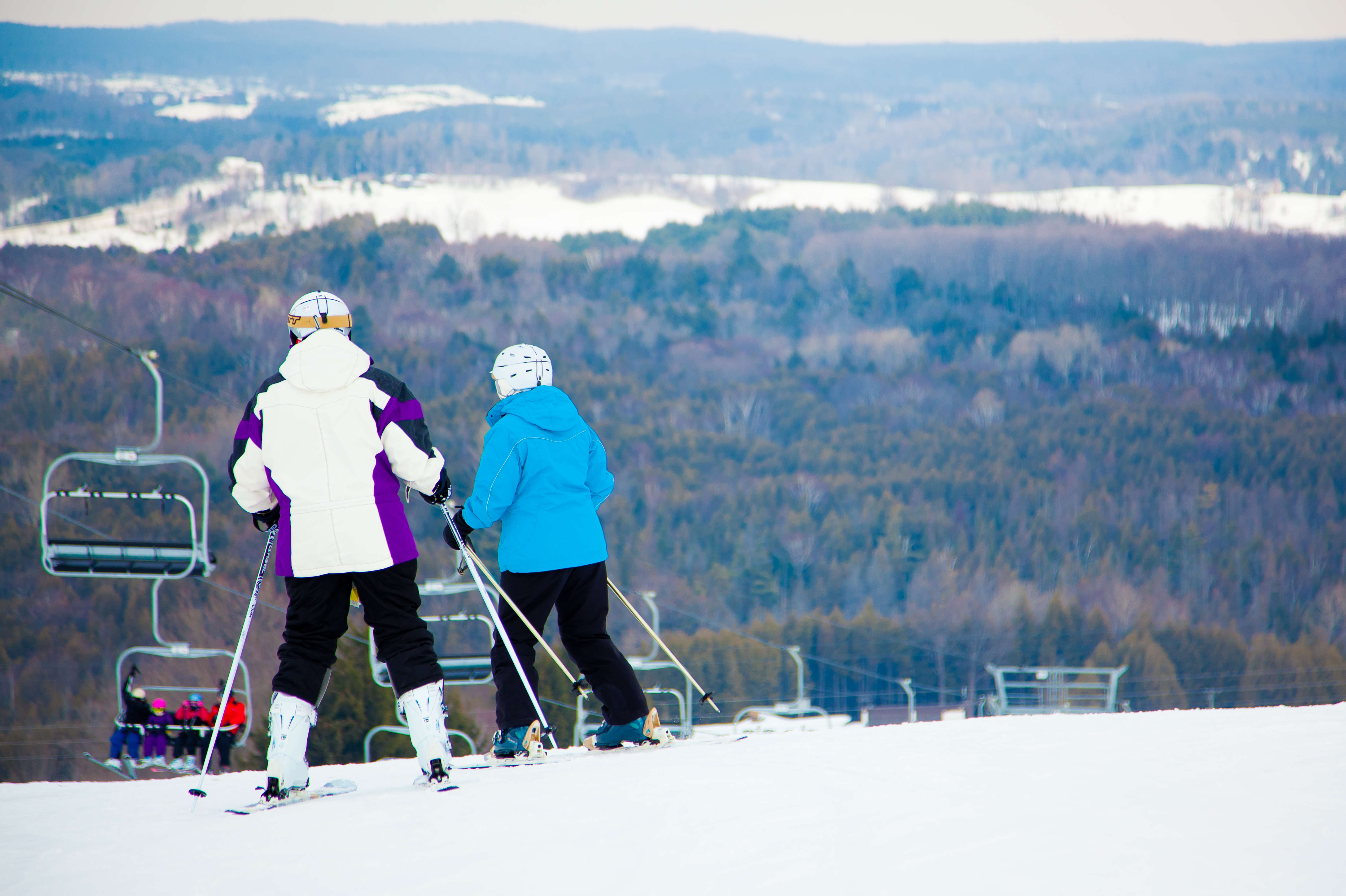 Couple skiing at the top of a hill at Brimacombe