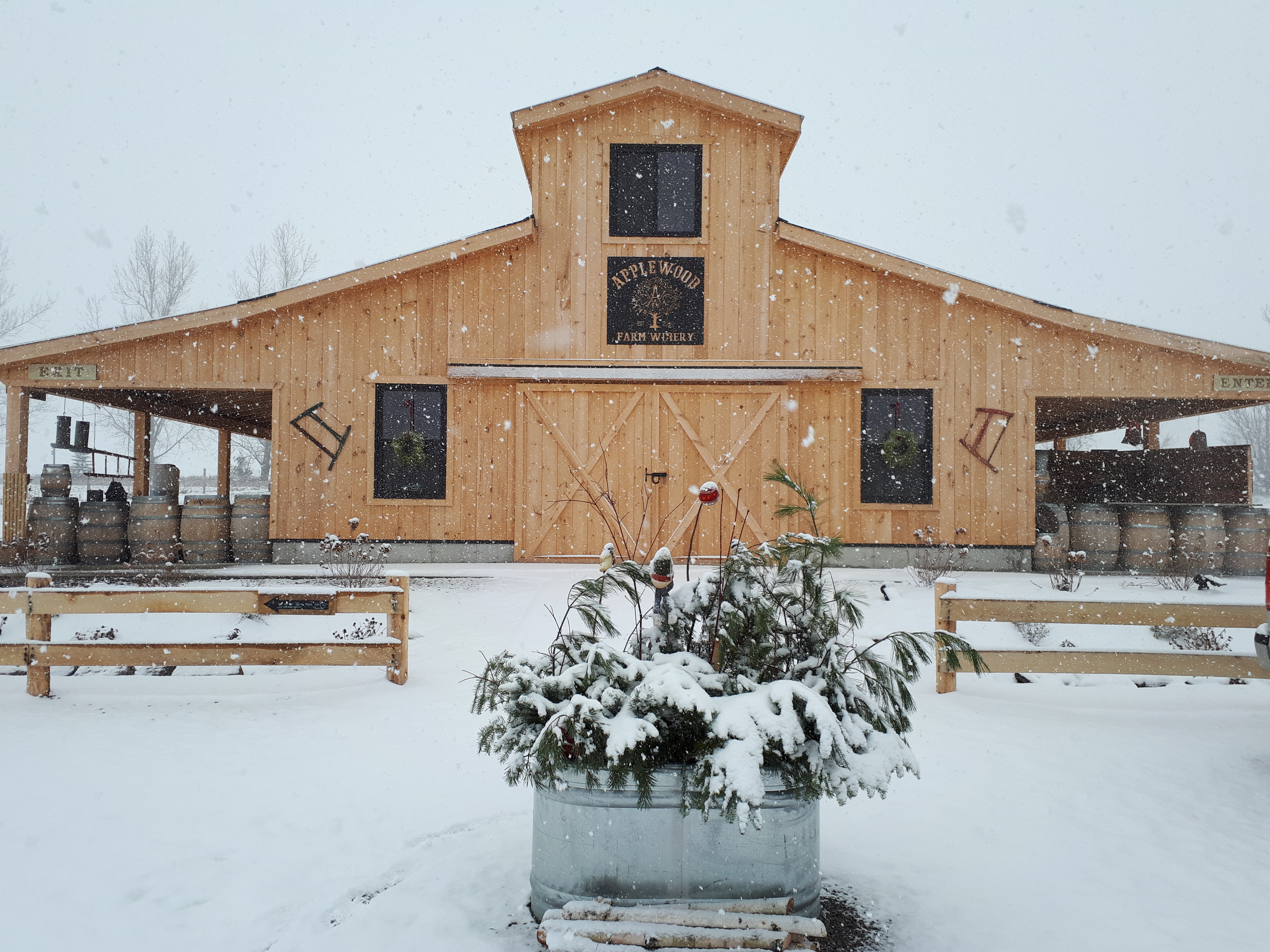 Exterior of Applewood Farm Winery wooden building with snow