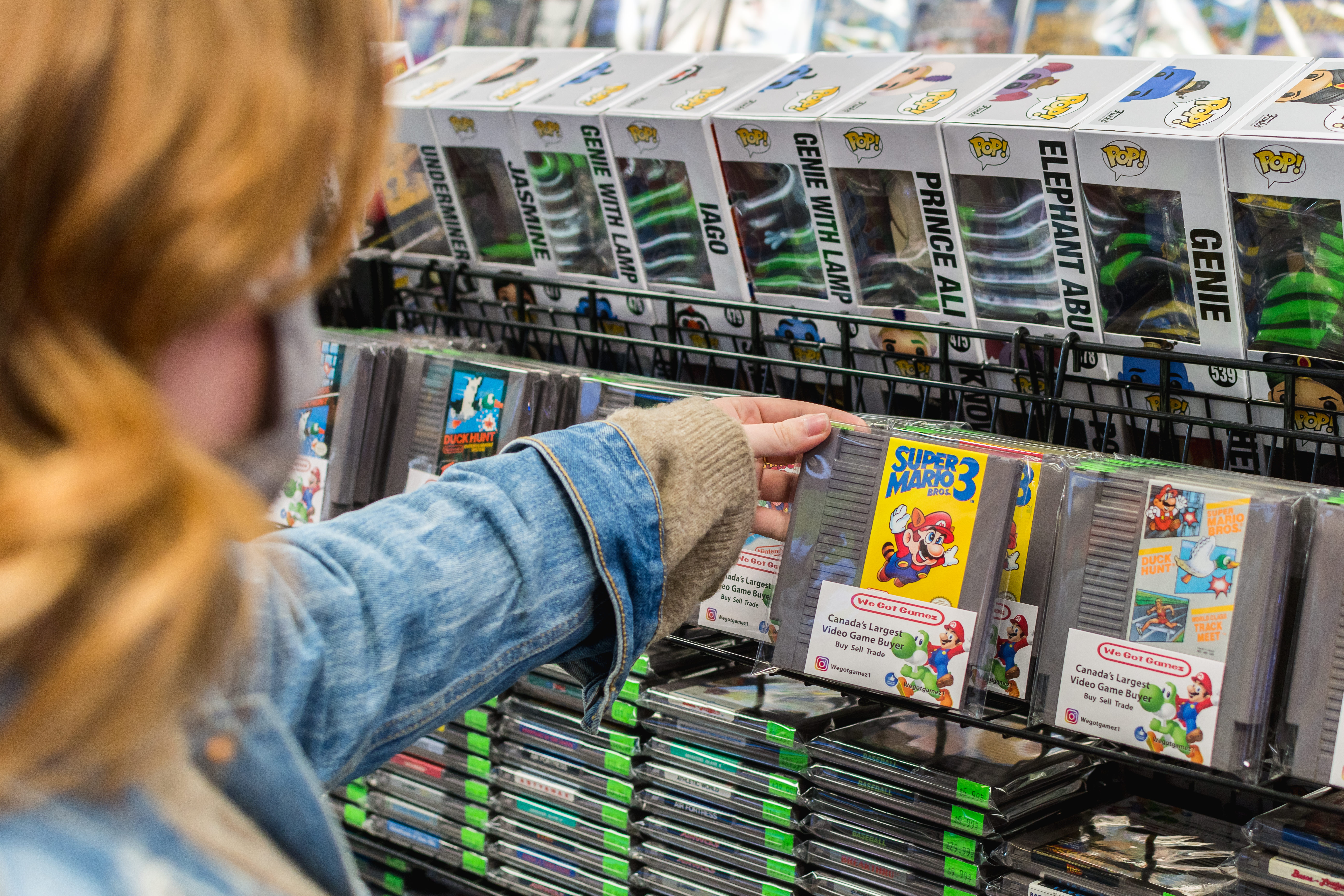 Woman browsing video games in store in Ajax
