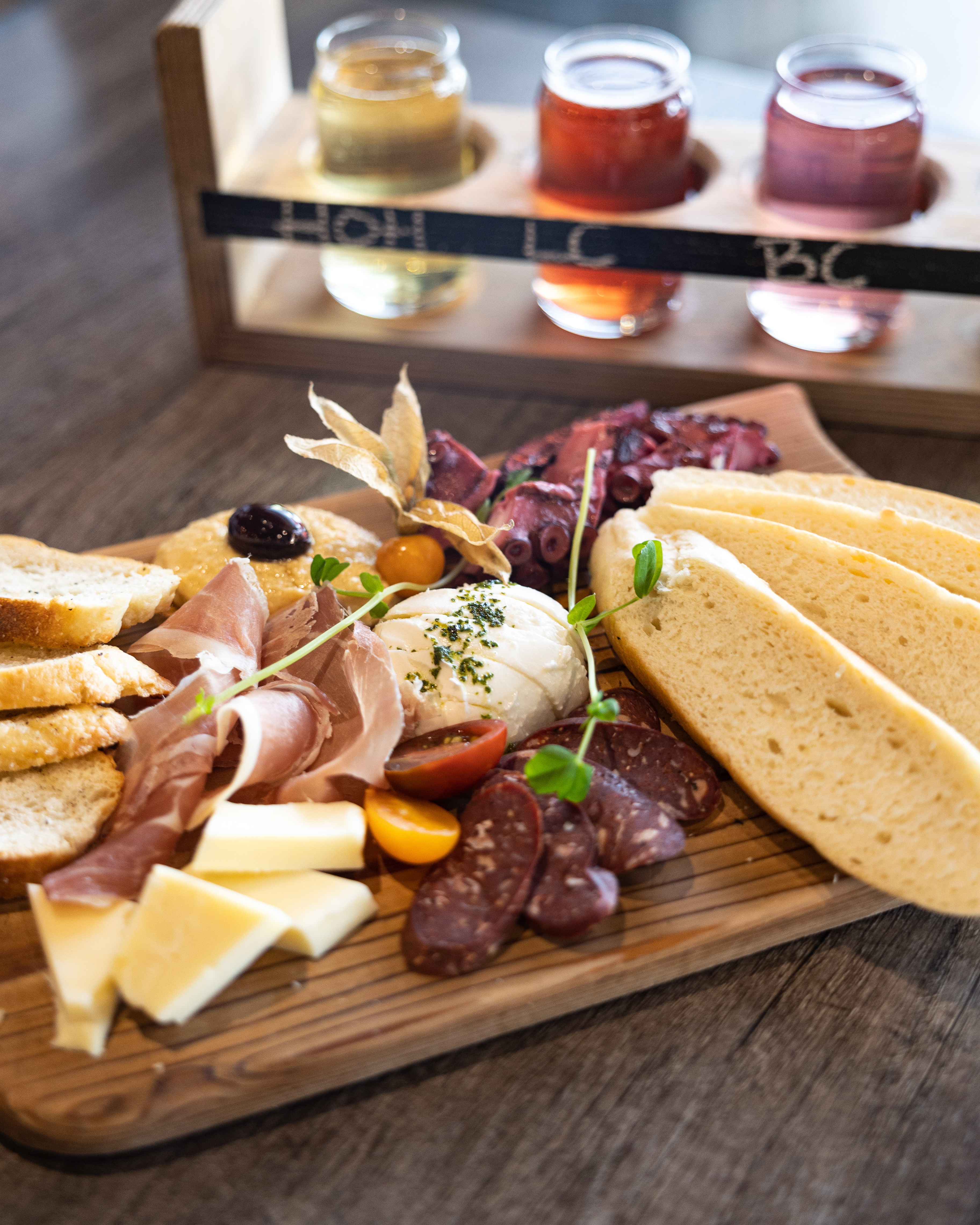 Charcuterie board with flight of three ciders