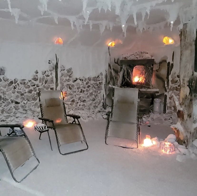 Chairs and salt lamps inside a holistic salt cave