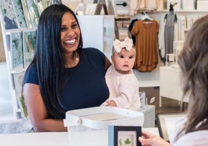 Woman and child buying merchandise at The Makers Hub