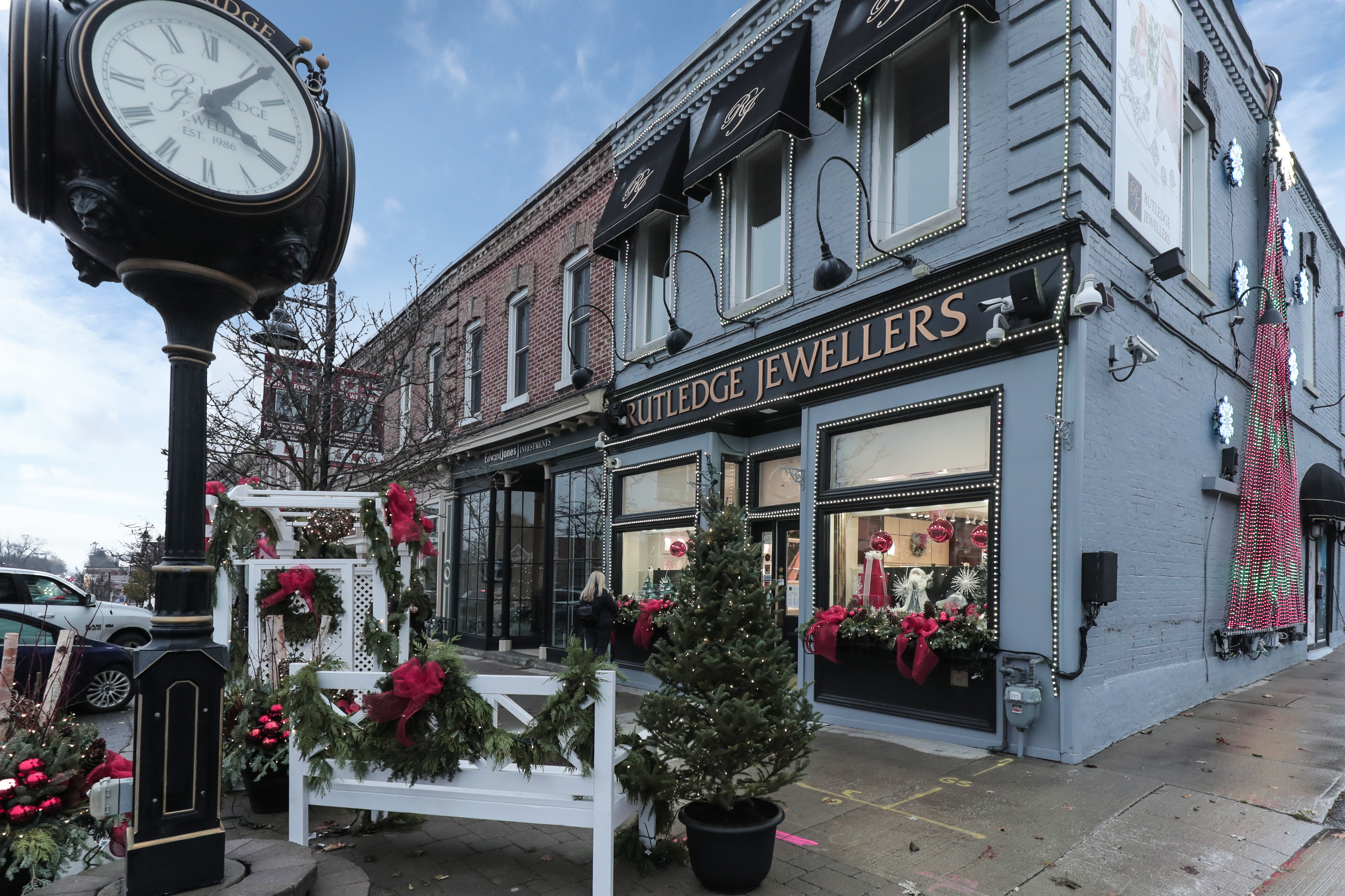Front of Rutledge Jewellers in Downtown Uxbridge with mini trees, red bows and holiday decorations.