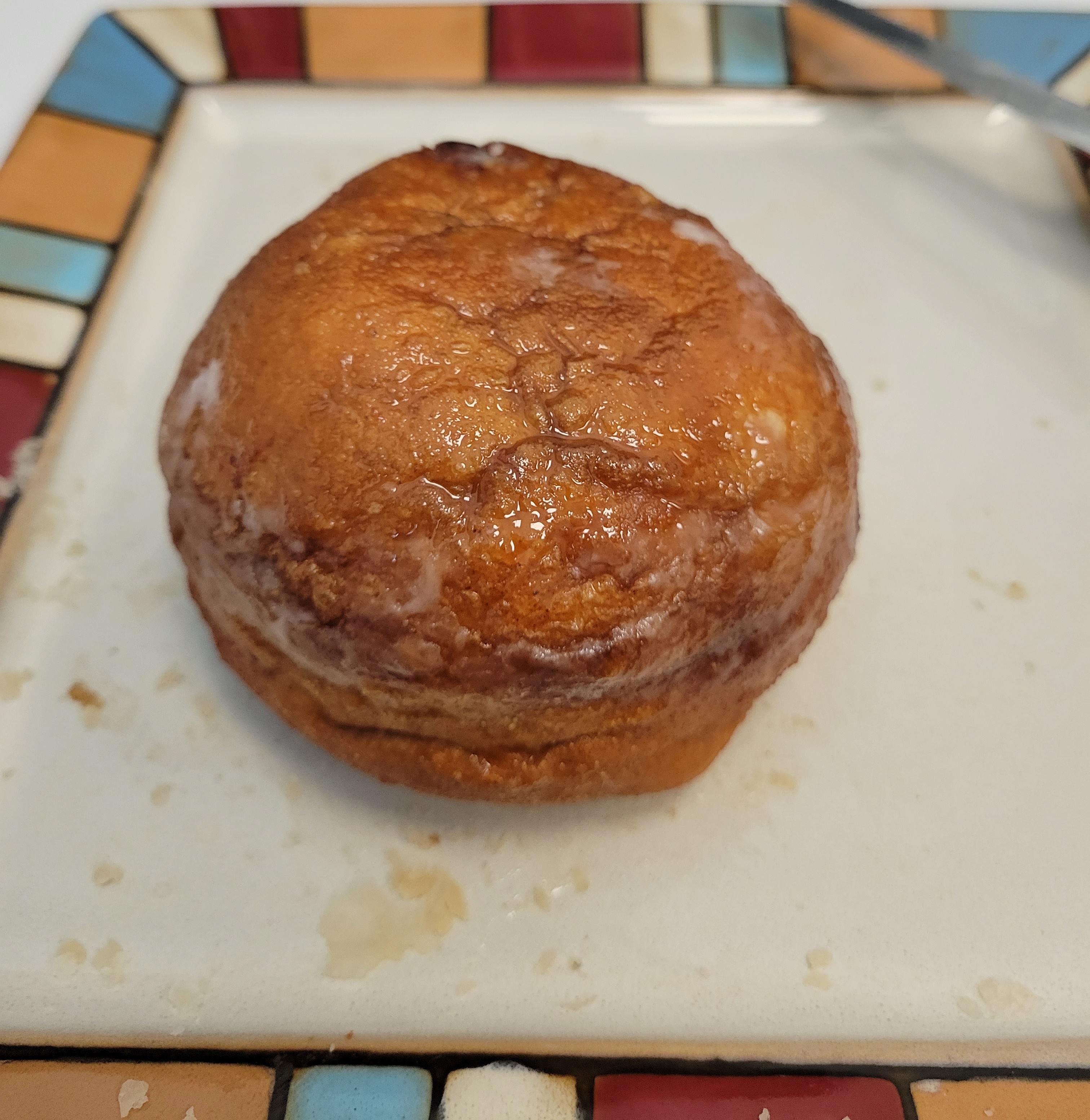 White Feather apple fritter on a colourful plate