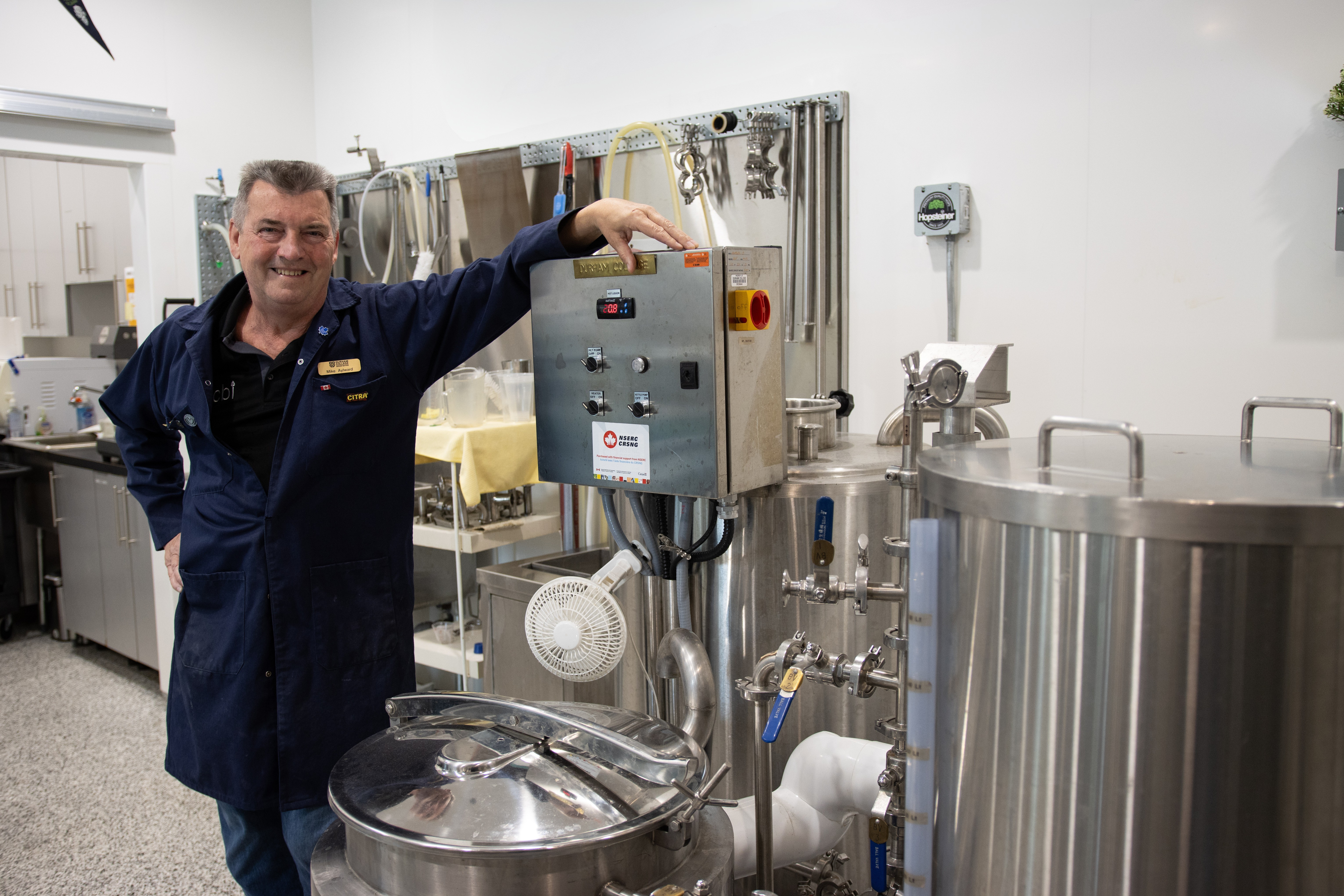 Chris standing next to brewing equipment at the Centre for Craft Beverage Innovation in Whitby, Ontario, Canada