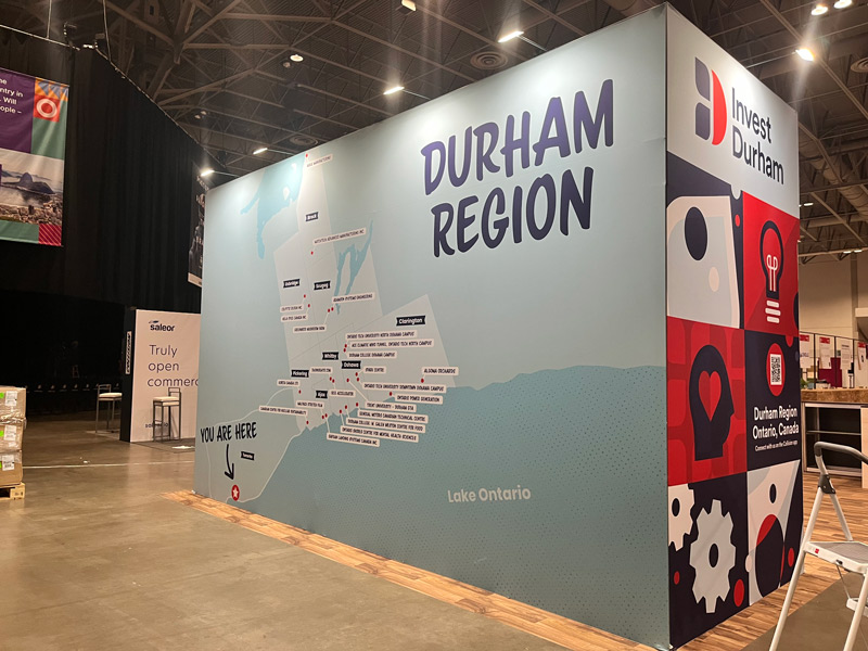 Back of the Invest Durham booth with a huge map of Durham Region.
