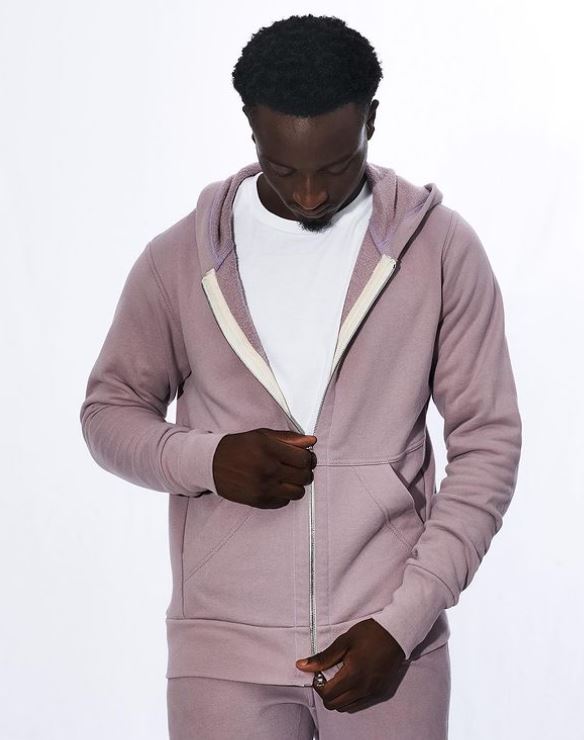 Image of person zipping up pink sweatshirt