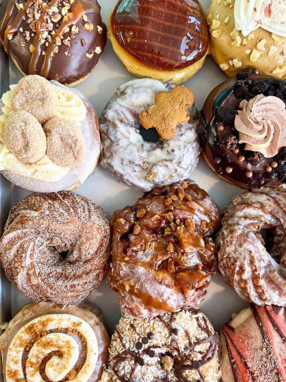 Close up of a variety of different types of gourmet donuts.