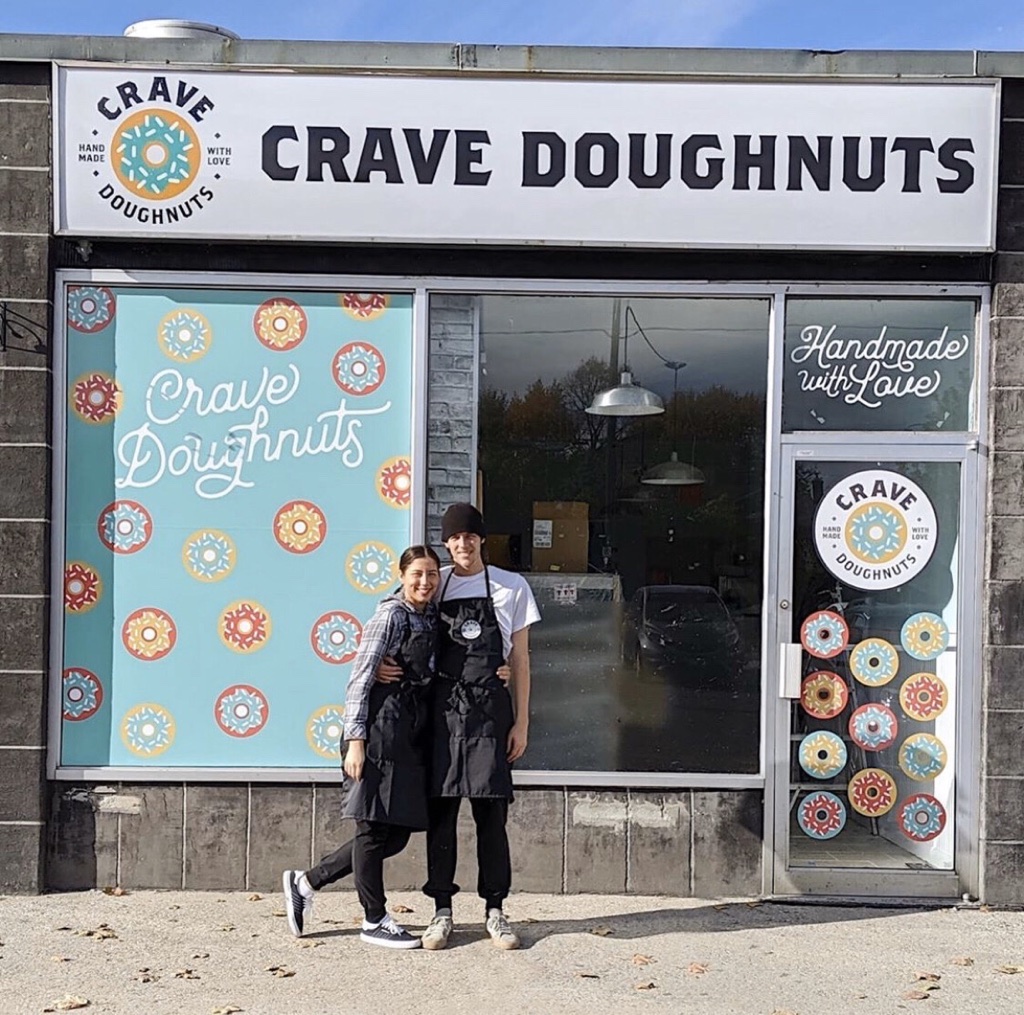 Founders standing outside the Crave Doughnuts storefront.