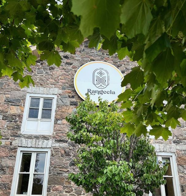 Rangeela sign on a stone building.