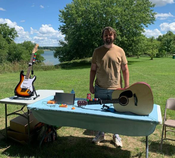 Inclusive Instruments guitars on display on a table at an outdoor event.