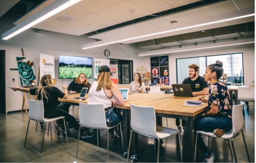 Group of students working at a large table.