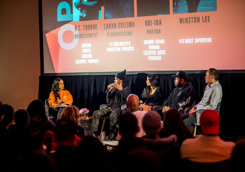 Panel of speakers at an event on stage.