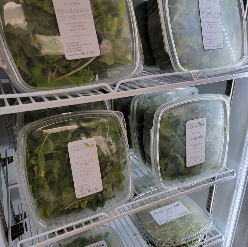 Close up of ready to purchase packages of mixed greens.