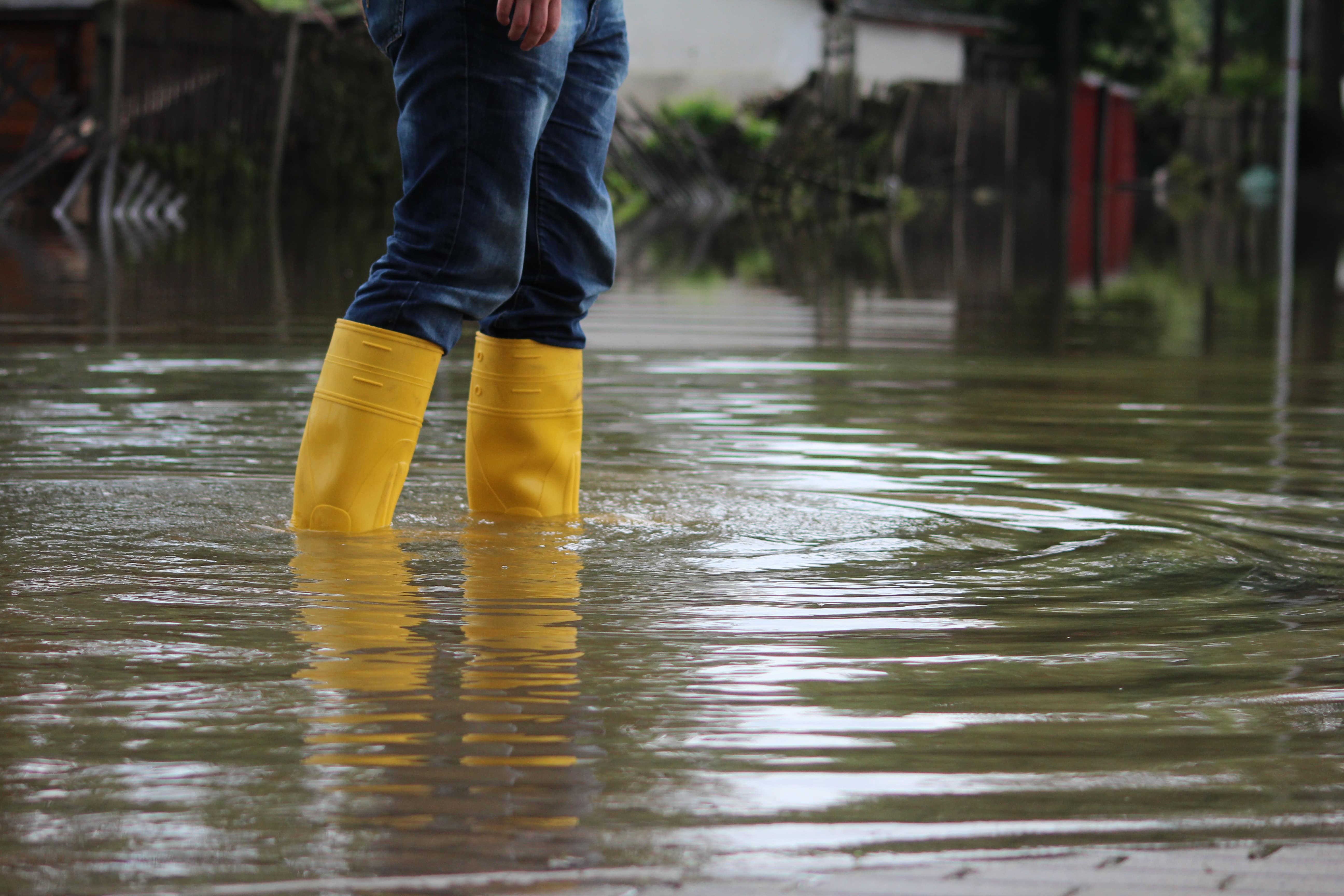 person will yellow rain boots standing in water