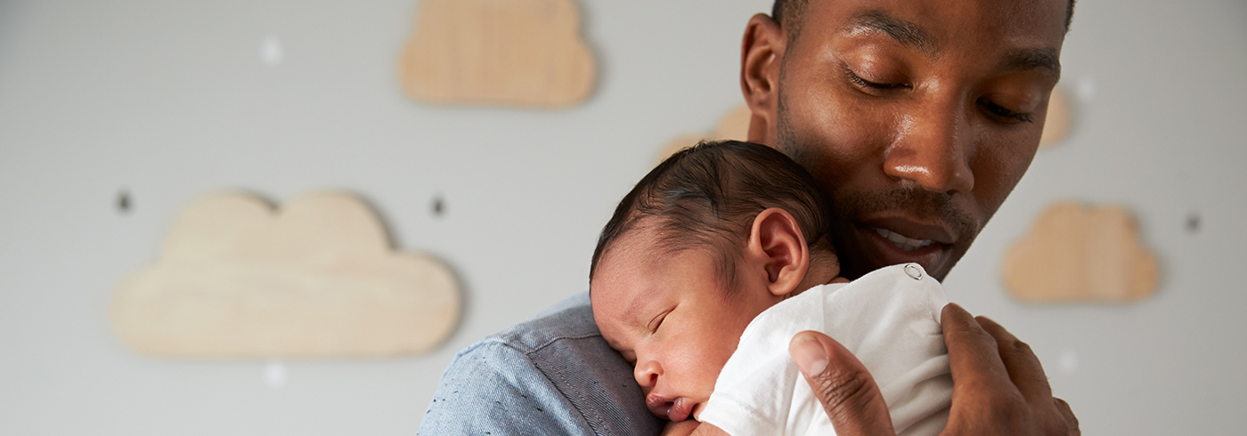 Father holding new baby