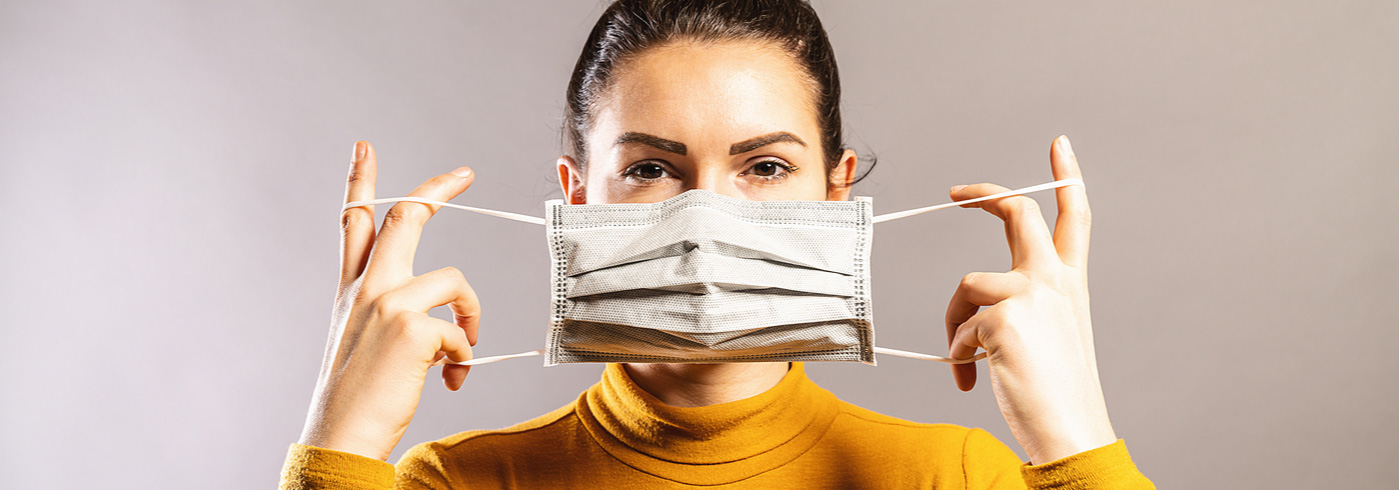 Woman putting on a mask.