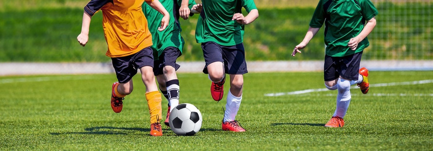 Young kids playing soccer.