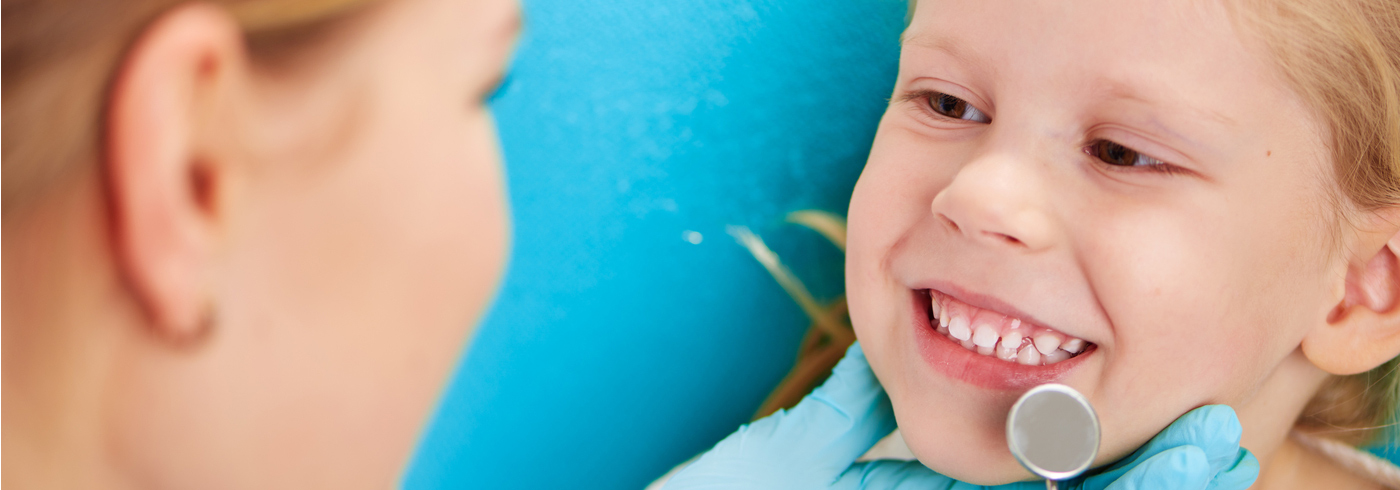 Child having teething checked by a registered dental hygienist.