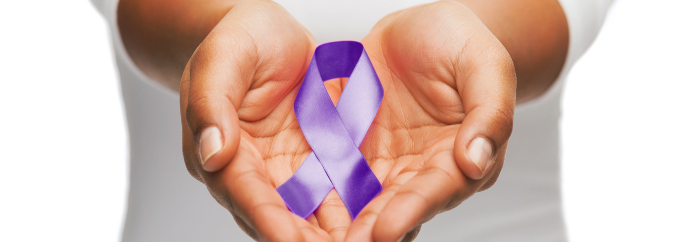 Hands holding purple domestic violence awareness ribbon.