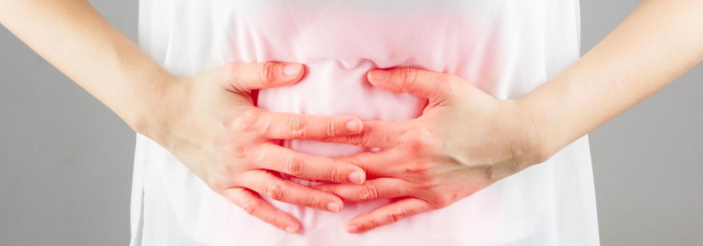 Woman holding her stomach.