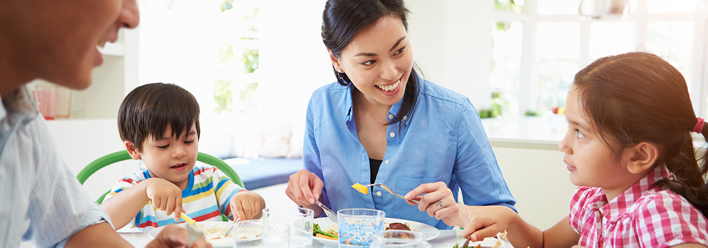 Family eating dinner together at home.