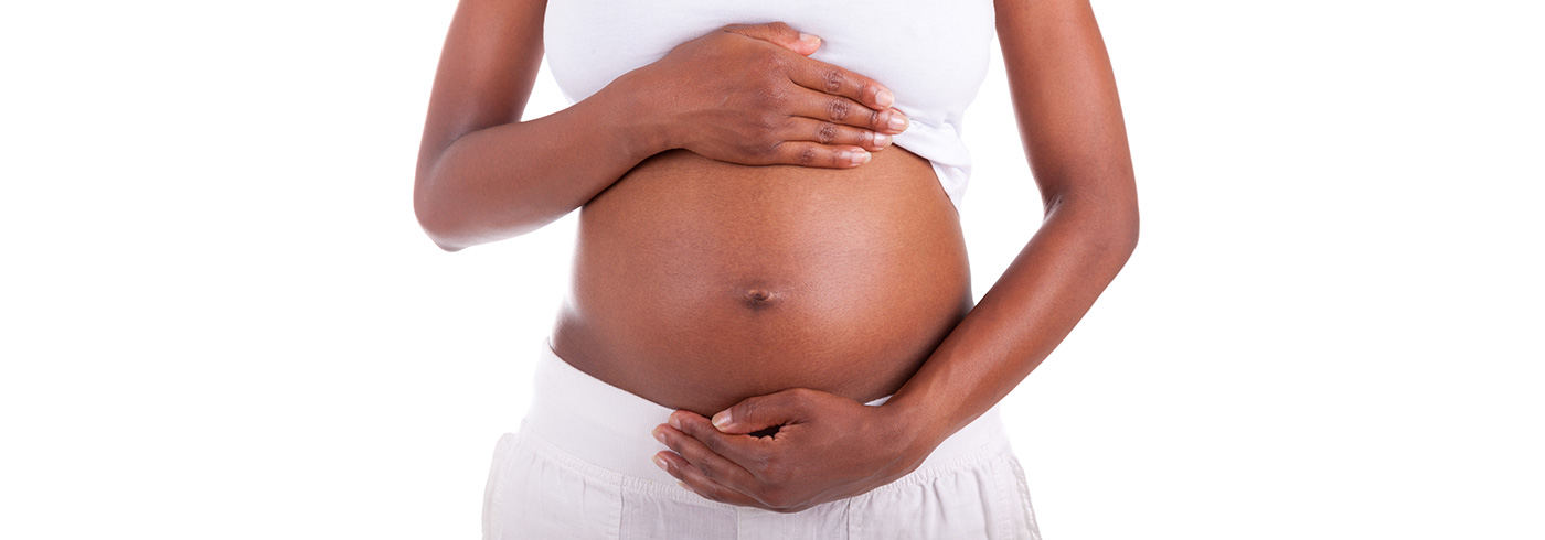 Woman holding her pregnant belly.