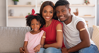 Family smiling after immunizations.