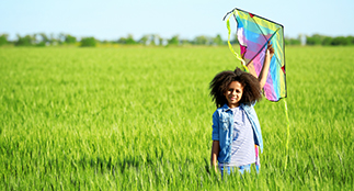 Girl holding a kite.