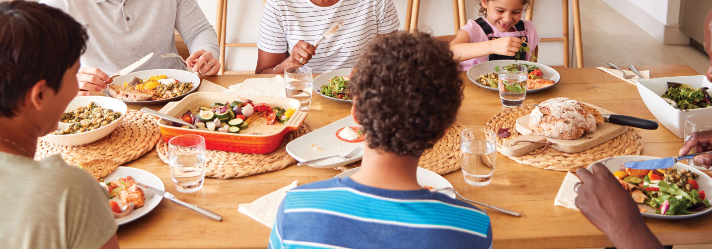 Family enjoying food at the dinner table.