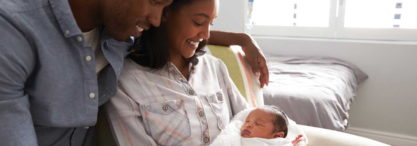 Couple holding newborn baby.