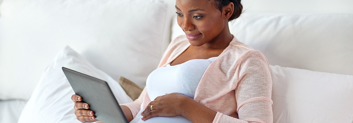 Pregnant woman on a tablet.