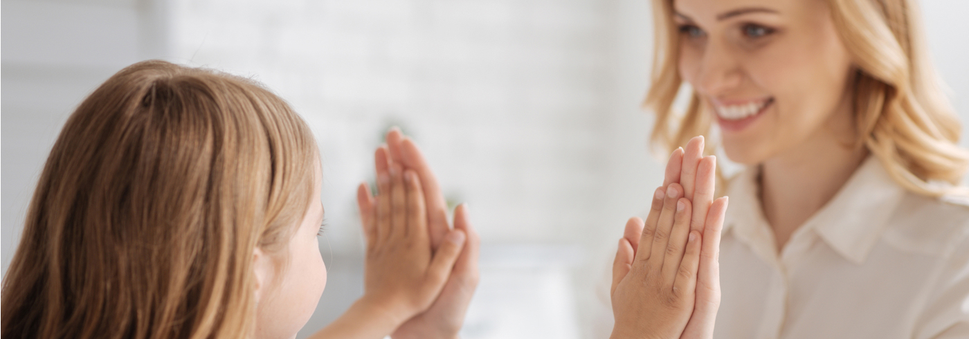 Mother and daughter giving high fives.