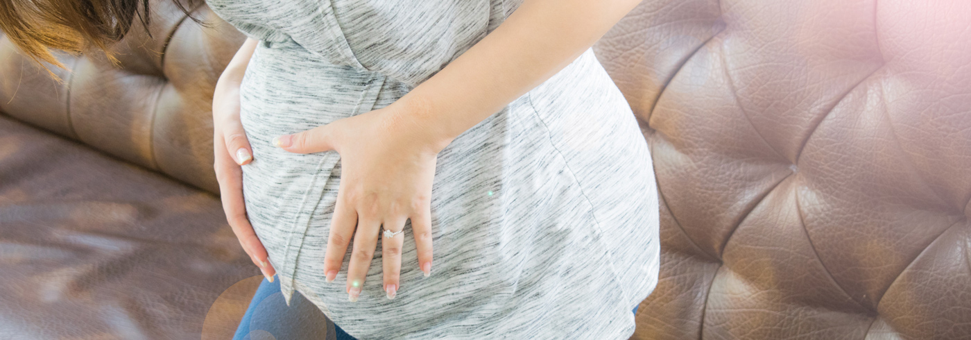 Woman holding her pregnant belly.